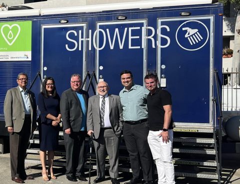 Salazar, Diaz, Hoenes, Cress, Stoltz, and Froemming (left to right) pose in front of the mobile shower, which has seven shower stalls. When guests check in, they are given a towel, washcloth, and shampoo.