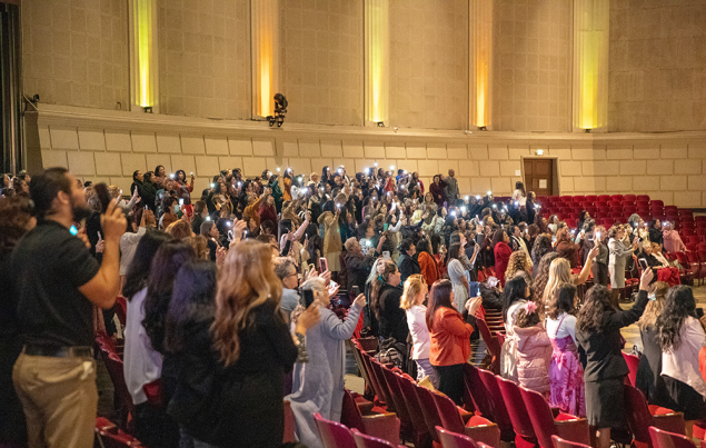 Attendees express excitement and joy as two women make decisions for baptism.