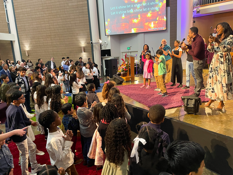 Children enjoy worship songs up close.