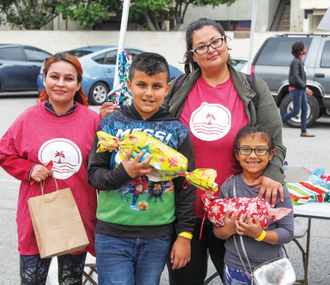 A family receives gifts and blessings from Long Beach church.