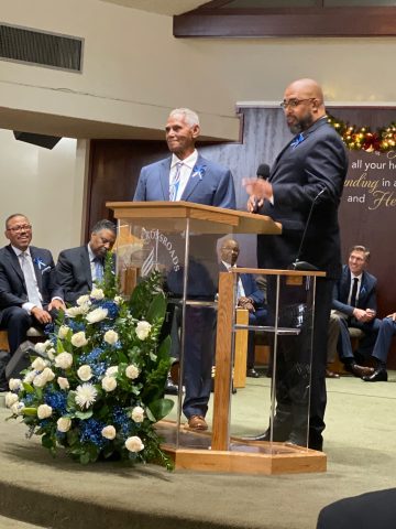 Darrett (right) and the congregation honor Valley Crossroads patriarch Davis (left).