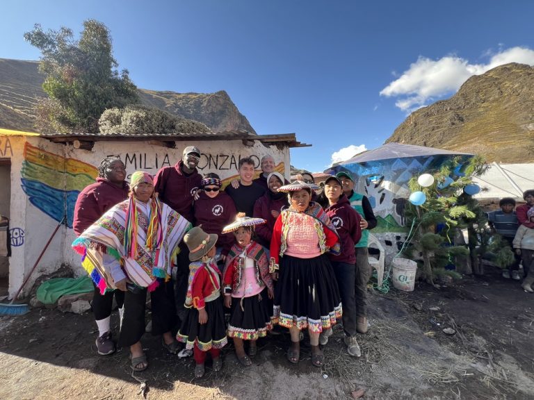 Mayor Samuel and his family outside their newly remodeled home in Japura.