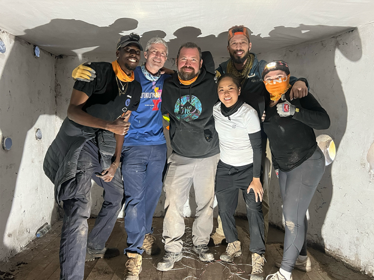 SCC missionaries gather inside one of the finished homes.